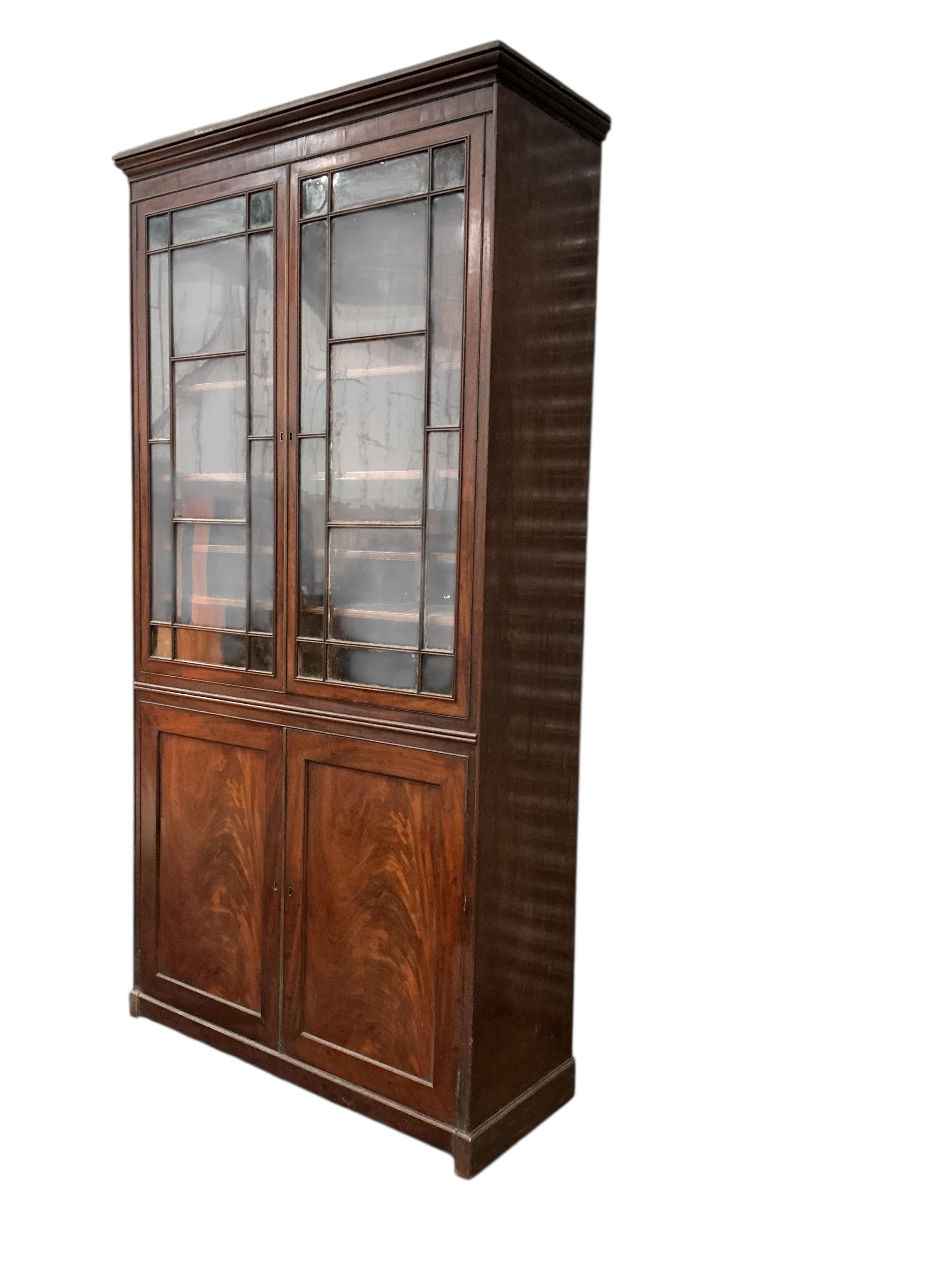 A George III mahogany bookcase, width 112cm, depth 42cm, height 225cm